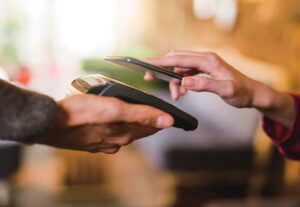 Contactless payment using a smart phone hand close up.