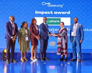 Ms Vedika Bhandarkar, President and Chief Operating Officer, Water.org (second right) presents the Leadership in Water Infrastructure and Finance Award to Ben Muriuki, Head of Investor Relations & Strategy at Co-op Bank.